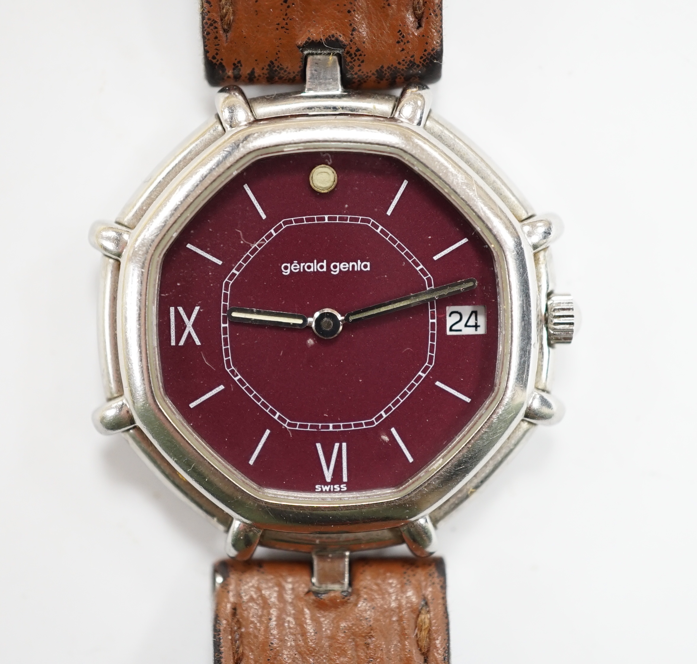 A gentleman's Swiss stainless steel Gerald Genta quartz octagonal wrist watch, with burgundy dial and Roman and baton numerals, on a leather strap, case diameter 32mm, with original box, leather pouch and guarantee.